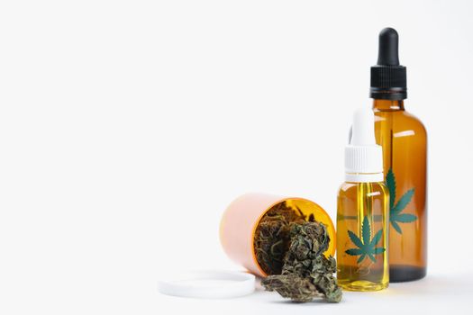 Close-up of dry marijuana buds extract oil and spray presented in bottle. Medication for home treatment. Alternative medicine, health concept. Copy space