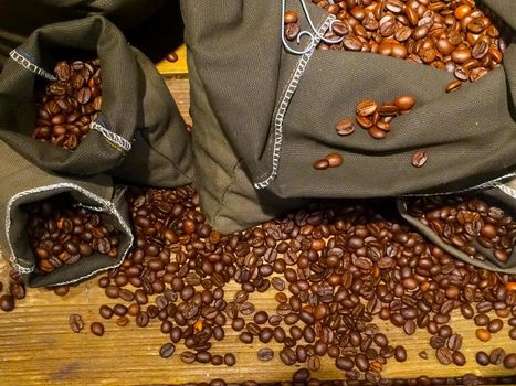 coffee beans on bags over rustic wood background