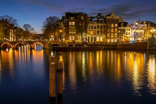 City scenic from Amsterdam at the river Amstel in the Netherlands at sunset