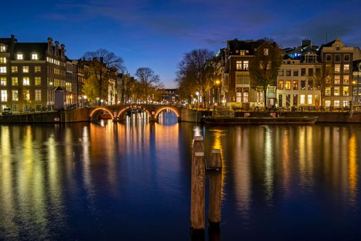 City scenic from Amsterdam at the river Amstel in the Netherlands at sunset