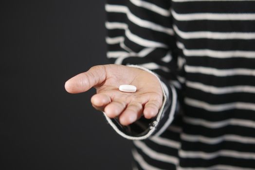 close up of medical pills on palm of child hand ,
