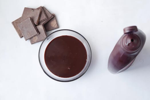 dark chocolate cream in a bowl on white .