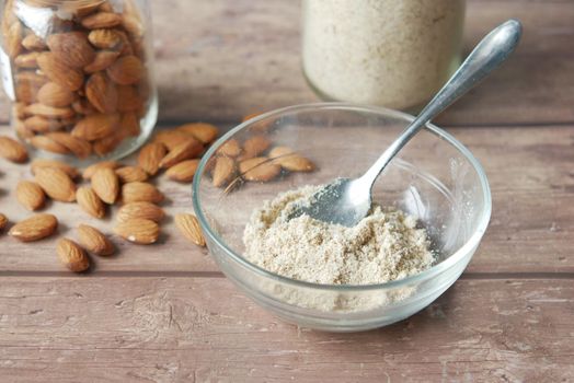 almond powder and almond in a jar on table