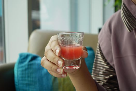 women drinking water melon drinks .