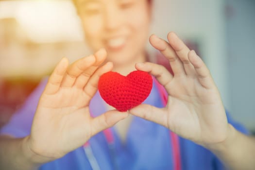 nurse sharing love red heart for health care giving medical help and donation together concept