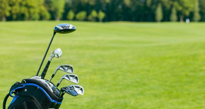 Golf clubs in a golf bag isolated. Set of golf clubs for a golfer. Copy Space. green Background. Close-up. High quality photo