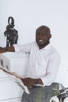 World Of Digital, Disappearance Of Paper Newspapers. Afro American Businessman Reads Newspaper To Houses. High quality photo