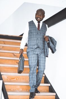 Happy Laughing Rich African American Businessman. Successful top manager in Stylish Expensive Suit coming down stairs. Concept Of Rich Life, Successful. High quality photo