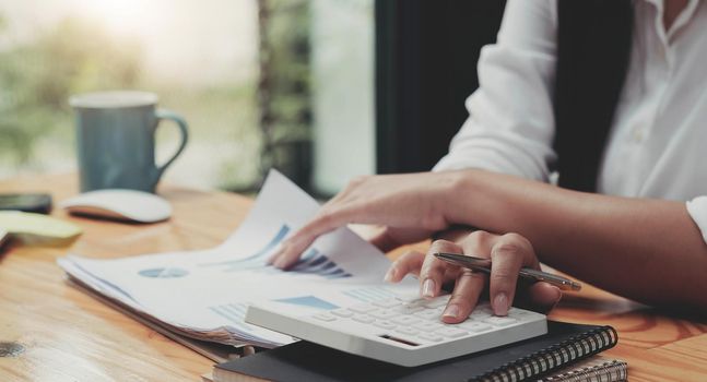 Business woman working in finance and accounting Analyze financial budget in the office.