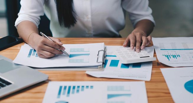 Businesswomen analyzing investment graph and discussing plan in meeting room, investment concept.