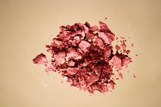 Crushed cosmetics, mineral organic eyeshadow, blush and cosmetic powder isolated on golden background, makeup and beauty banner, flatlay design.