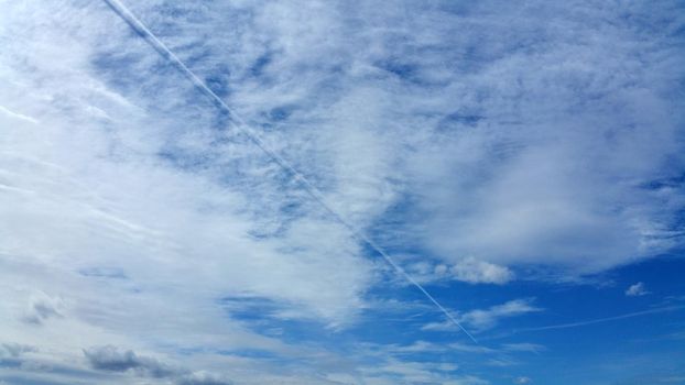 White clouds on the blue sky background. Panoramic photo.