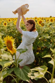 woman with two pigtails walks through a field of sunflowers unaltered. High quality photo