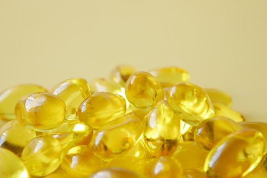 fish oil supplement on orange background .
