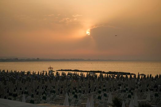 Rimini beach at sunset with yellow sky Riviera Romagnola. High quality photo