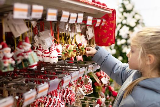 A girl choose the toys for the Christmas tree