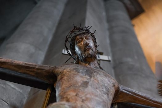 A statue of Jesus hanging on a cross in a church