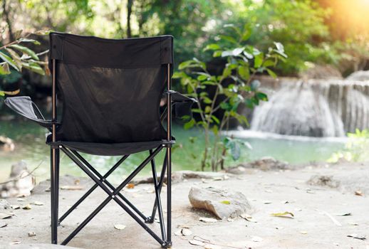 Empty Camping Chair with waterfalls background.  Relax time