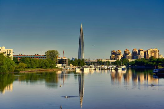 Skyscraper of Gazprom in St. Petersburg with fucking in river against background of a blue sky, cityscape on summer sunny day