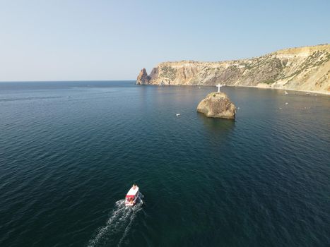 Aerial panoramic view of beautiful sunset above sea. Beautiful seascape. Sun glare, small waves on the water surface. Evening. Horizon. Nobody. No people. Copy space. Never-ending beauty of nature