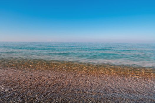 Morning calm sea. Marine background haze over the sea surface during calm weather.