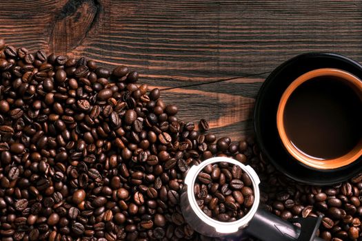 Coffee cup and coffee beans on wooden background. Top view. Still life. Copy space. Flat lay.