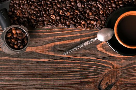 Coffee cup and coffee beans on wooden background. Top view. Still life. Copy space. Flat lay.