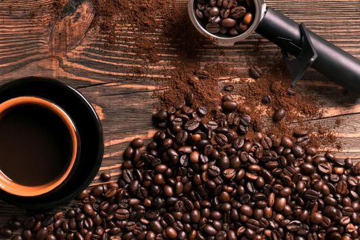 Coffee cup and beans frame on wooden table. Top view. Copy space. Still life. Mock-up. Flat lay