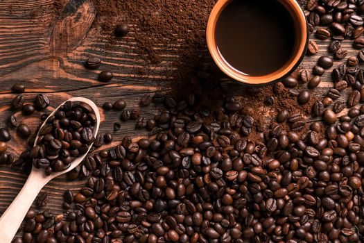 Coffee cup and beans frame on wooden table. Top view. Copy space. Still life. Mock-up. Flat lay