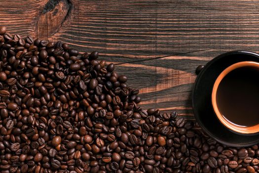 Coffee cup and beans frame on wooden table. Top view. Copy space. Still life. Mock-up. Flat lay