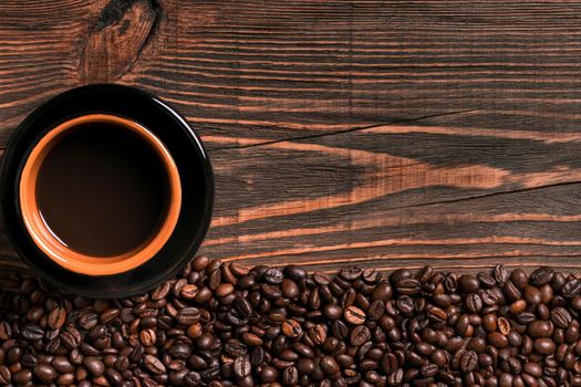 Coffee cup and beans frame on wooden table. Top view. Copy space. Still life. Mock-up. Flat lay