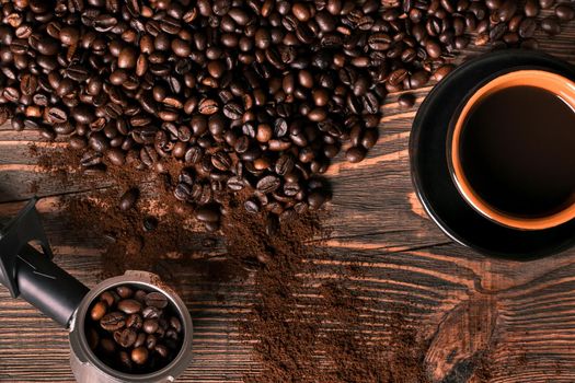 Coffee cup and coffee beans on wooden background. Top view. Still life. Copy space. Flat lay.