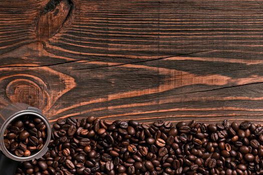 Coffee beans on wooden table texture with copy space. View from above. Still life. Flat lay. Mock-up