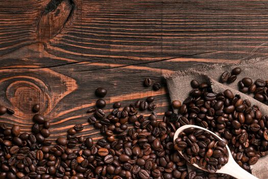 Coffee beans on wooden table texture with copy space. View from above. Still life. Flat lay. Mock-up