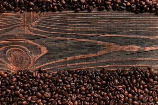 Coffee beans on wooden table texture with copy space. View from above. Still life. Flat lay. Mock-up