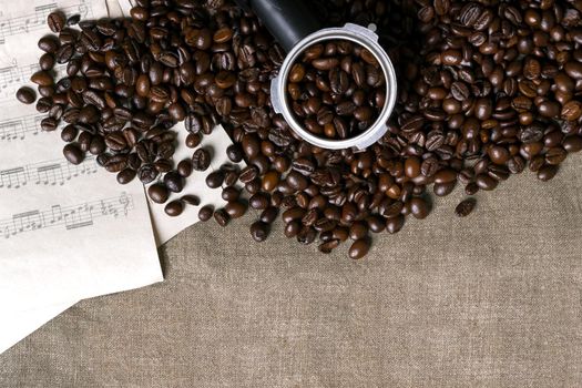 Coffee beans and sheet music on burlap background. Top view. Copy space. Still life. Mock-up. Flat lay