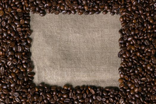 Coffee beans on burlap background. Top view. Copy space. Still life. Mock-up. Flat lay