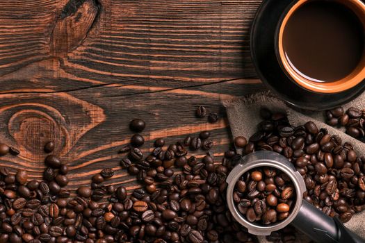 Coffee cup and beans frame on wooden table. Top view. Copy space. Still life. Mock-up. Flat lay