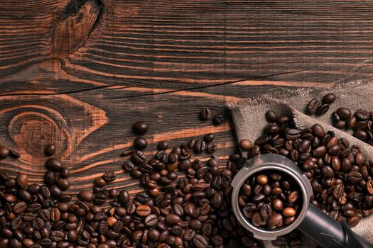 Coffee beans on wooden table texture with copy space. View from above. Still life. Flat lay. Mock-up