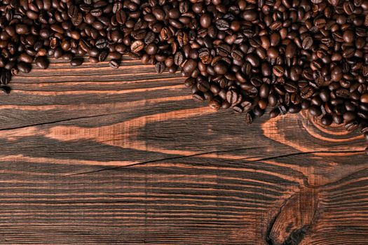 Coffee beans on wooden background. Top view. Still life. Copy space. Flat lay.