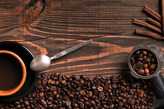 Coffee cup and beans frame on wooden table. Top view. Copy space. Still life. Mock-up. Flat lay