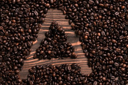 Letter A inscription with coffee bean on the wooden table. Top view. Copy space. Still life. Mock-up. Flat lay