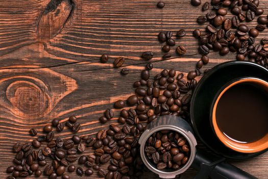 Coffee cup and beans frame on wooden table. Top view. Copy space. Still life. Mock-up. Flat lay