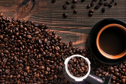 Coffee cup and beans frame on wooden table. Top view. Copy space. Still life. Mock-up. Flat lay