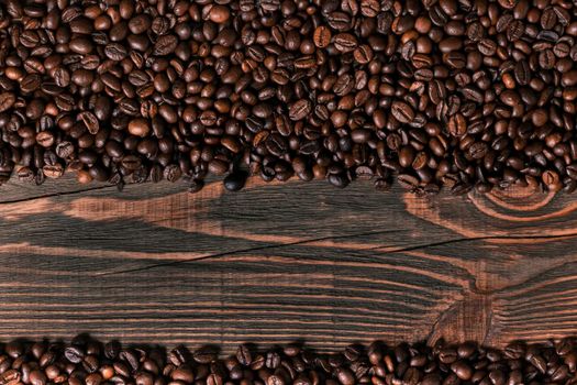 Coffee beans on wooden background. Top view. Still life. Copy space. Flat lay.