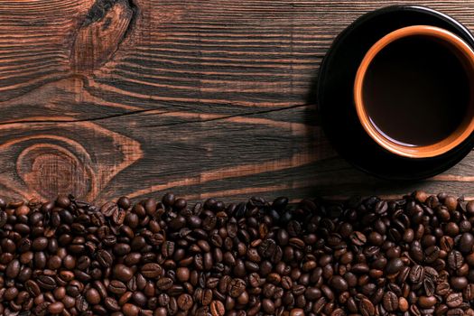 Coffee cup and beans frame on wooden table. Top view. Copy space. Still life. Mock-up. Flat lay