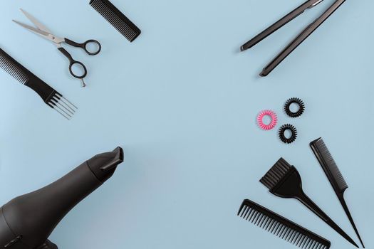 Hairdresser set with various accessories on gray background. Top view. Copy space. Still life. Mock-up. Flat lay