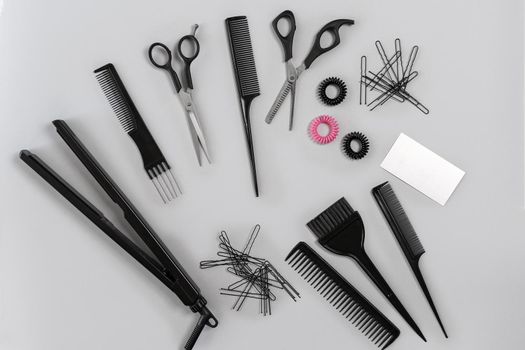 Hairdresser set with various accessories on gray background. Top view. Still life. Flat lay.