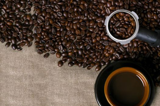 Coffee beans and Coffee cup on a burlap background. Top view. Copy space. Still life. Mock-up. Flat lay
