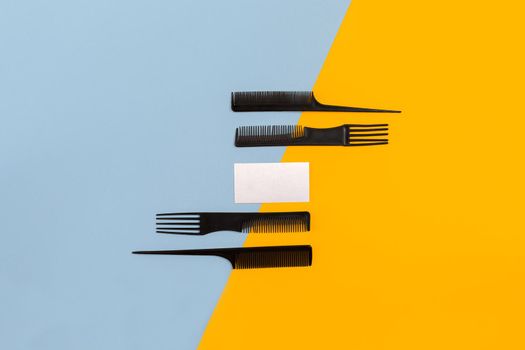 Set of combs on blue and yellow background. Top view. Copy space. Still life. Mock-up. Flat lay